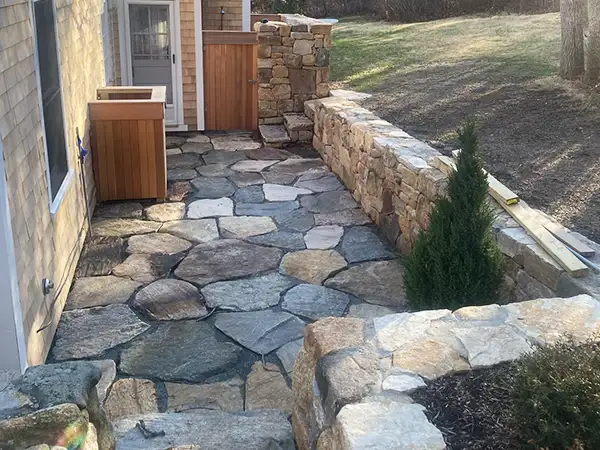 Stone patio, retaining wall and outdoor shower construction project
